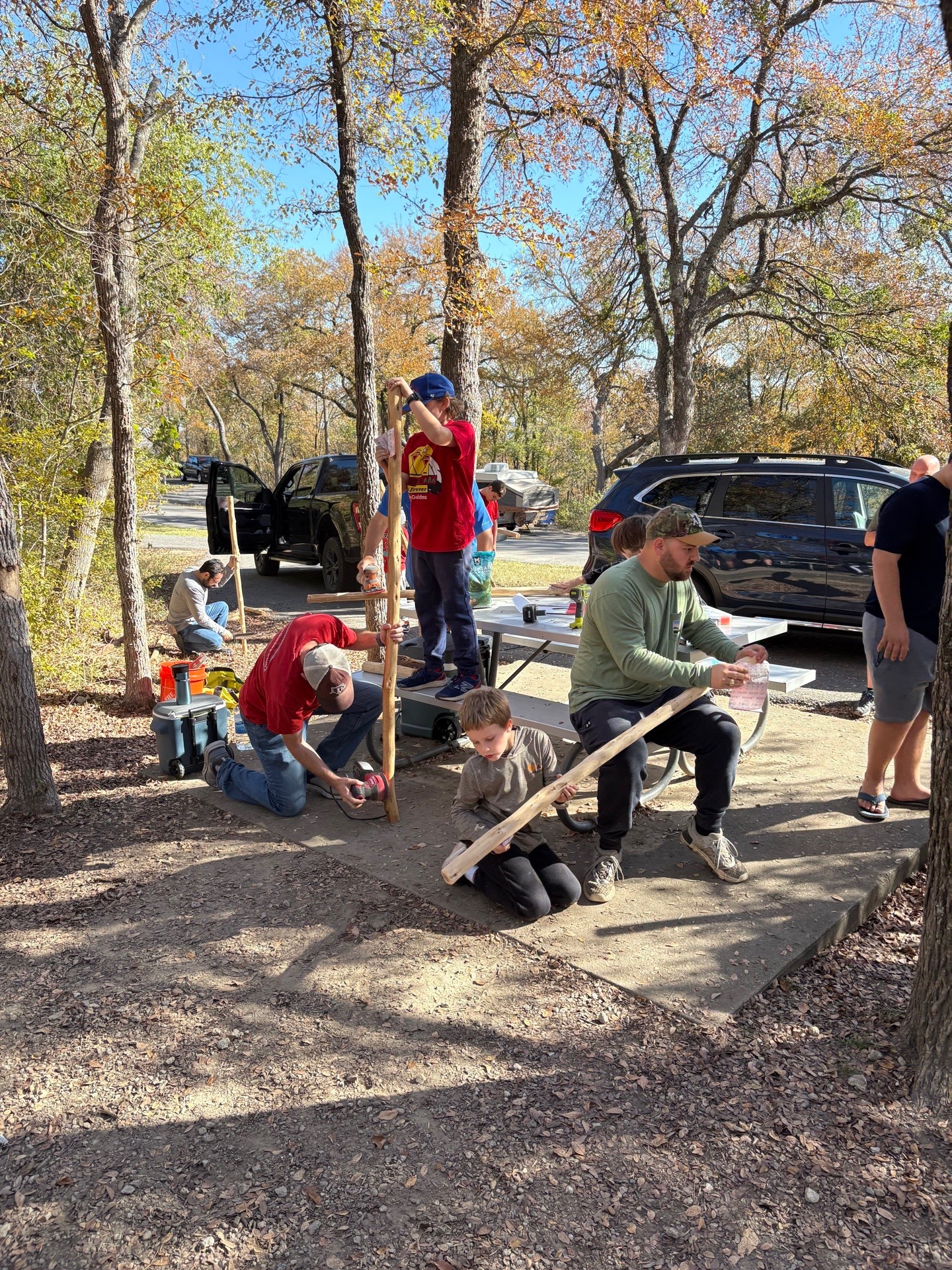 Dads and sons building together at campout